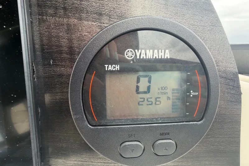 Slide: The Image of Yamaha tachometer display on 2023 Stingray 231 DC boat, showing 256 hours. - 23