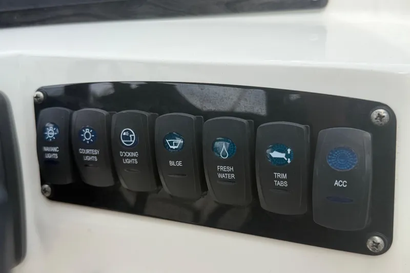 Slide: The Image of Control panel of 2023 Stingray 231 DC boat with labeled switches. - 26