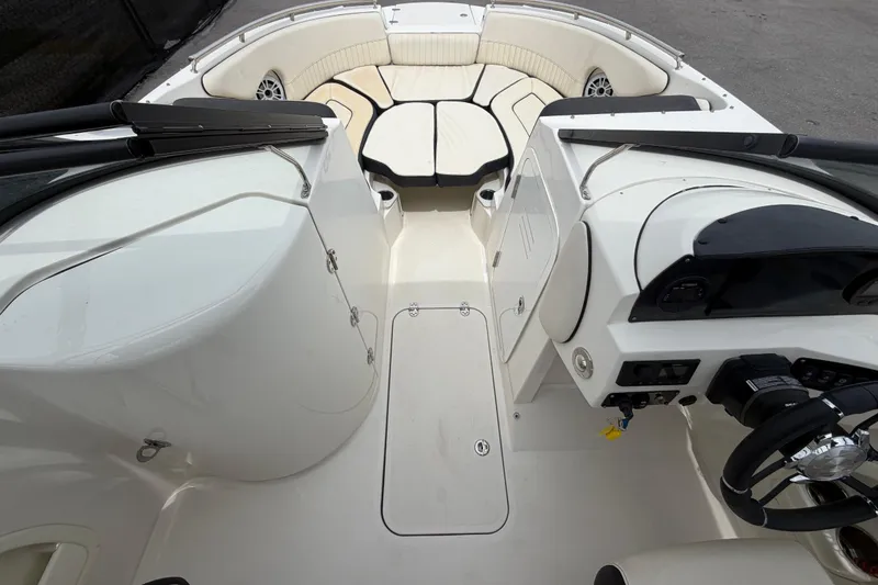 Slide: The Image of 2023 Stingray 231 DC boat interior with white seating and modern dashboard. - 28