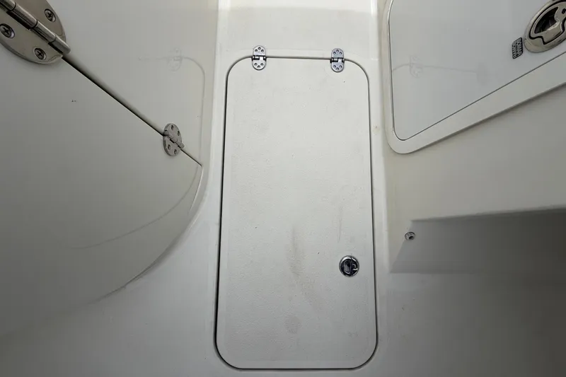 Slide: The Image of Interior of 2023 Stingray 231 DC boat with storage hatch. - 29