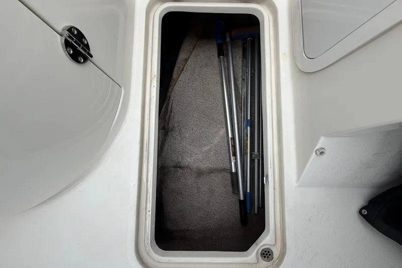 Slide: The Image of Stingray 231 DC 2023 storage compartment with poles inside. - 30