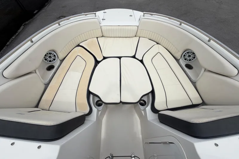Slide: The Image of 2023 Stingray 231 DC boat interior with cushioned seating and built-in speakers. - 31