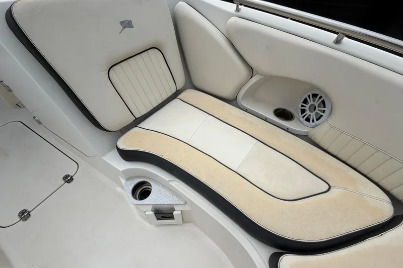 Slide: The Image of 2023 Stingray 231 DC boat interior with cushioned seating and speaker. - 34