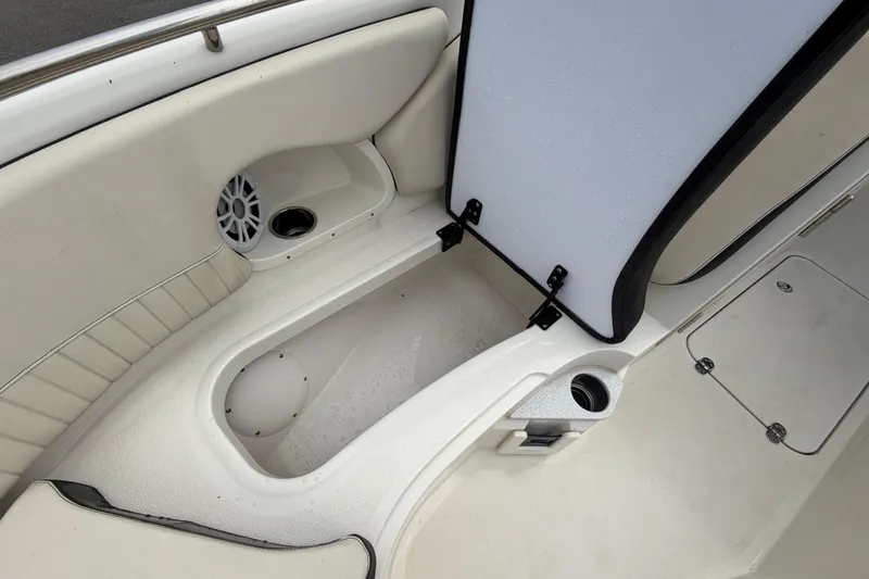 Slide: The Image of 2023 Stingray 231 DC boat interior with storage compartment and speaker. - 41