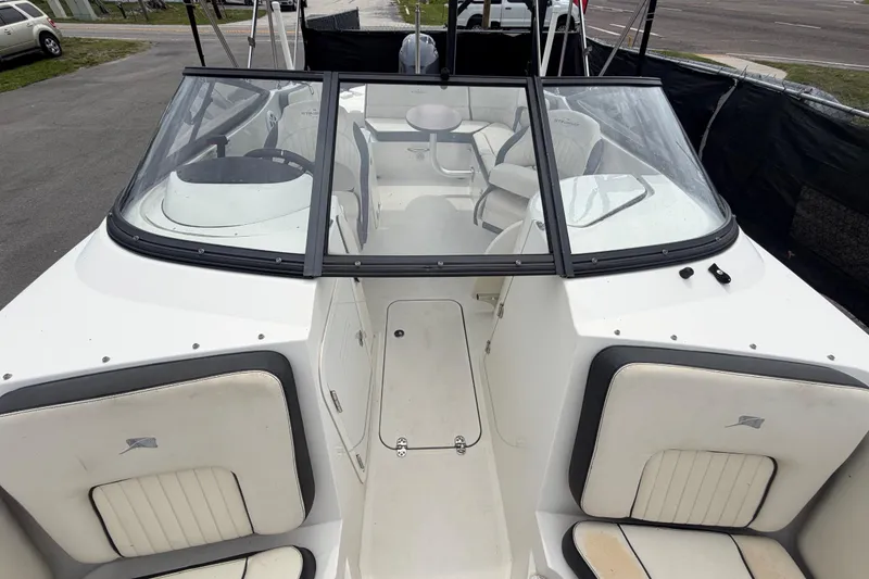 Slide: The Image of 2023 Stingray 231 DC boat interior with seating and windshield view. - 45