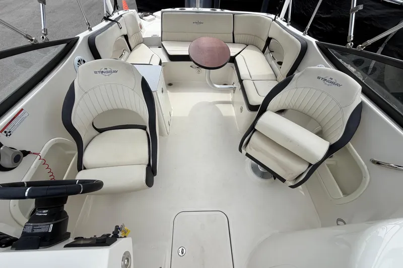 Slide: The Image of Interior of 2023 Stingray 231 DC boat with seating area and table. - 46