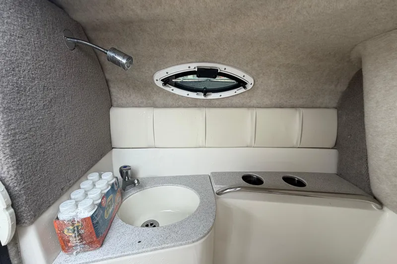 Slide: The Image of Interior of 2023 Stingray 231 DC with sink and cup holders. - 50