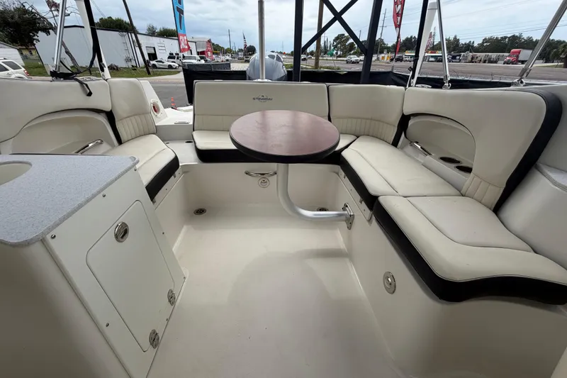 Slide: The Image of Interior of 2023 Stingray 231 DC boat with seating and table. - 53