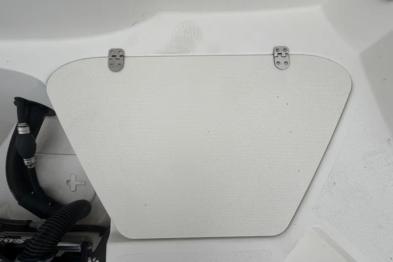 Slide: The Image of 2023 Stingray 231 DC boat hatch with hinges and textured surface. - 62