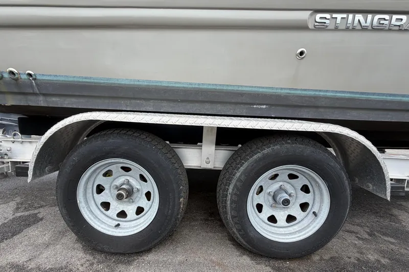 Slide: The Image of Trailer with dual wheels supporting a 2023 Stingray 231 DC boat. - 72