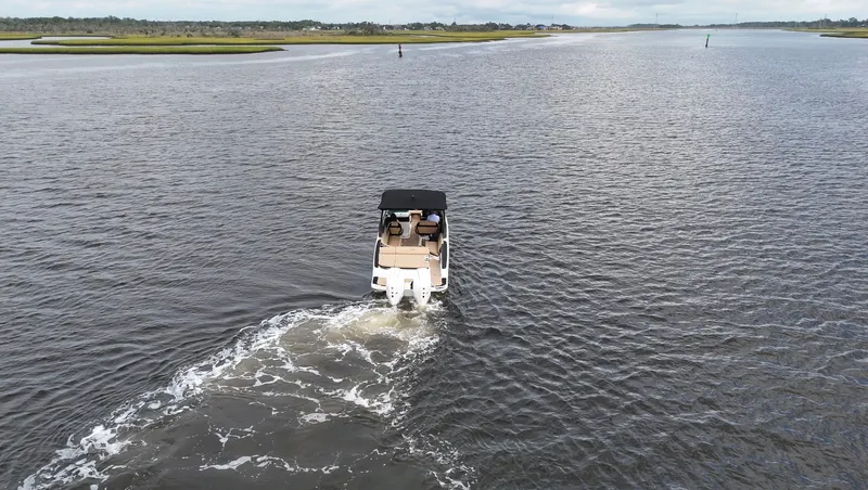 Slide: The Image of A 2027 Sea Ray SLX 280 Outboard cruising on calm waters with a green shoreline. - 3