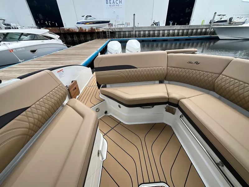 Slide: The Image of Interior view of a Sea Ray SLX 280 Outboard with sleek, cushioned seating and teak flooring. - 18