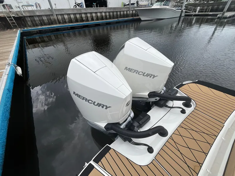 Slide: The Image of Two Mercury outboard engines on a boat in the water. - 13