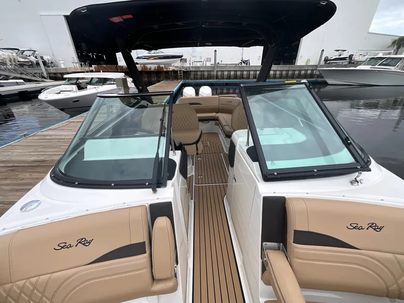 Slide: The Image of The image shows a 2027 Sea Ray SLX 280 Outboard boat with sleek seating and glass windows. - 29