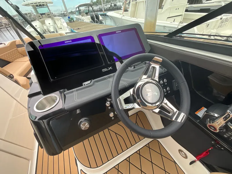 Slide: The Image of The image shows the cockpit of a 2027 Sea Ray SLX 280 Outboard with modern instruments. - 21