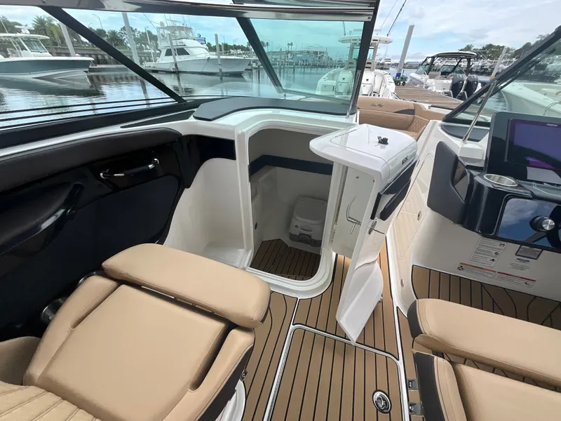 Slide: The Image of Interior view of a Sea Ray SLX 280 Outboard with beige seating and cabin access. - 34