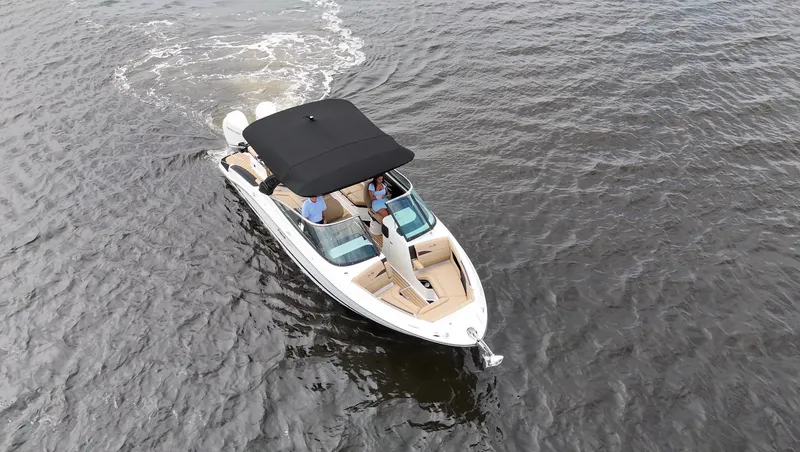 Slide: The Image of A 2027 Sea Ray SLX 280 Outboard cruising on calm water. It features a black sunshade. - 5