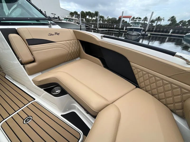 Slide: The Image of The image shows the luxurious cockpit of a Sea Ray SLX 280 Outboard with beige upholstery. - 26