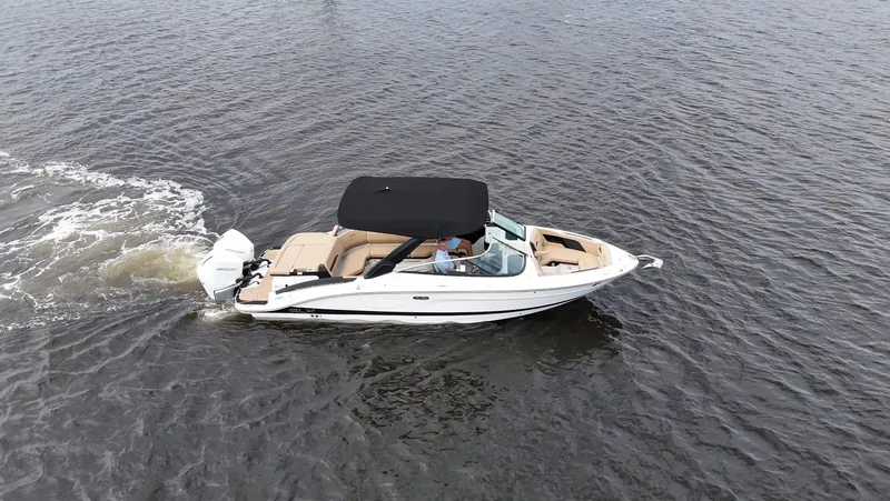 Slide: The Image of A 2027 Sea Ray SLX 280 Outboard cruising on calm water. It features a black canopy. - 4