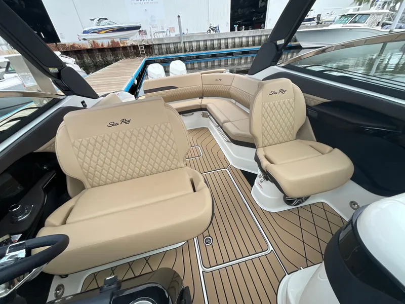 Slide: The Image of The image shows the interior of a Sea Ray SLX 280 Outboard with elegant beige seating. - 32
