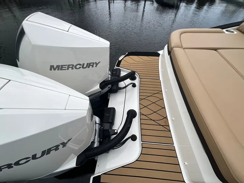 Slide: The Image of Two Mercury outboard engines on a Sea Ray SLX 280 boat, with a sleek, cushioned deck. - 14