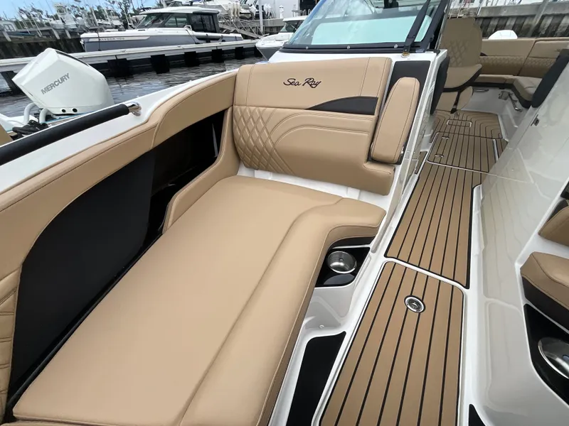 Slide: The Image of The image shows the interior of a Sea Ray SLX 280 Outboard with elegant beige upholstery. - 28