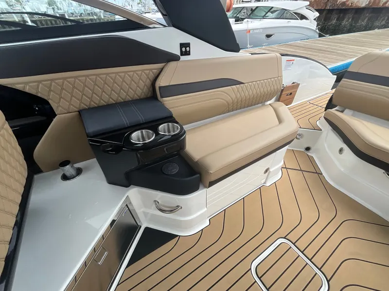 Slide: The Image of Interior of a Sea Ray SLX 280 Outboard with sleek seating and cup holders. - 17