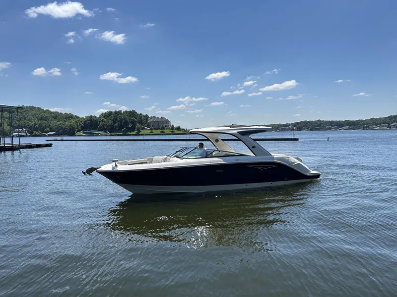 Slide: The Image of A 2026 Sea Ray SLX 310 on calm waters under a blue sky. - 2