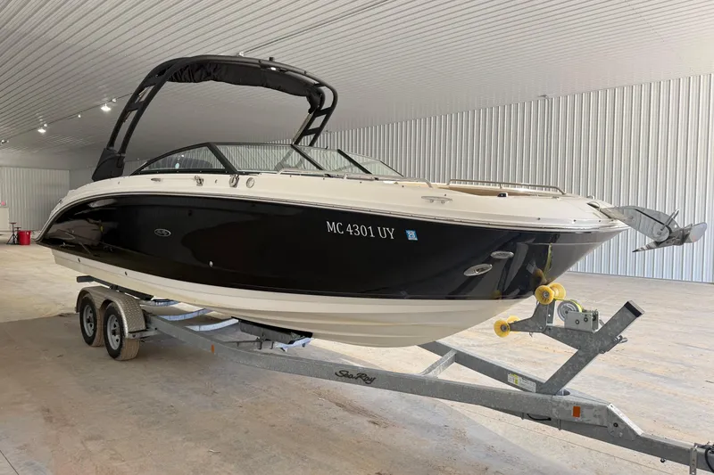Slide: The Image of 2023 Sea Ray SDX 290 boat on trailer in indoor storage facility. - 1