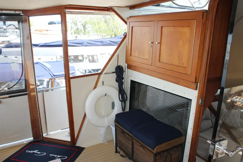 Slide: The Image of Interior of 1987 Chris-Craft 427 Catalina yacht with wooden cabinets and nautical decor. - 12