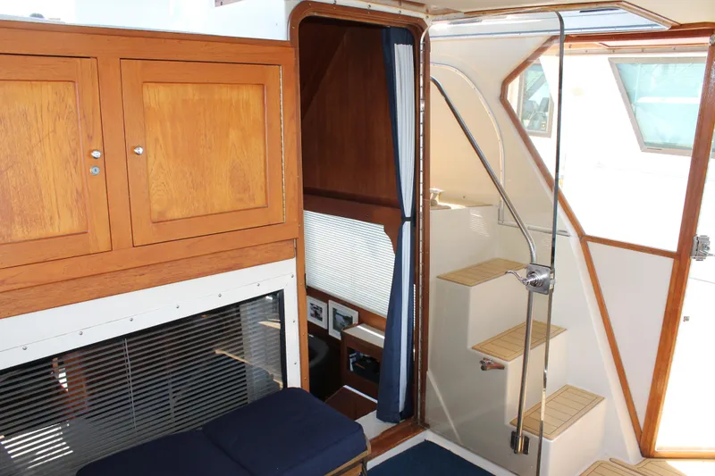 Slide: The Image of Interior of 1987 Chris-Craft 427 Catalina yacht with wooden cabinetry and stairs. - 15