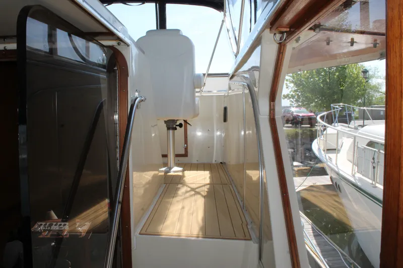 Slide: The Image of 1987 Chris-Craft 427 Catalina yacht deck with wooden flooring and sleek design. - 16