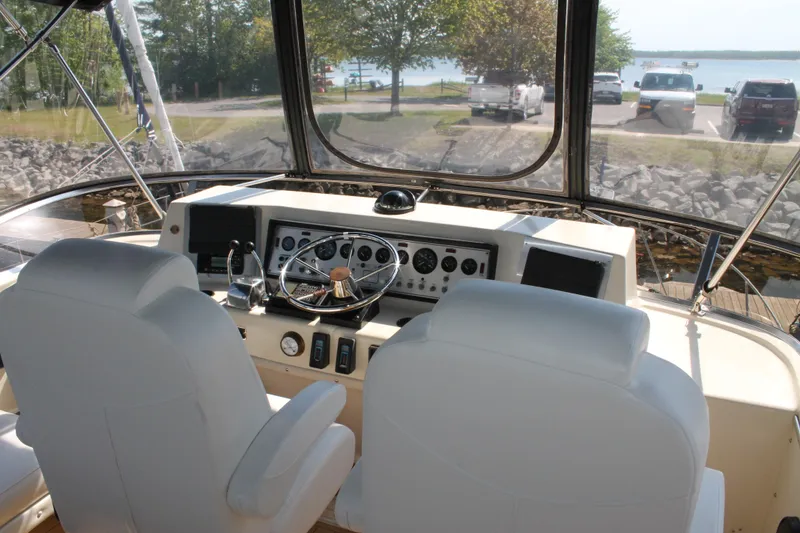 Slide: The Image of 1987 Chris-Craft 427 Catalina helm with dual seats, steering wheel, and control panel. - 17
