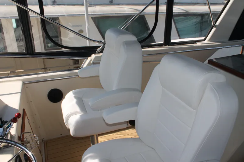 Slide: The Image of Interior of 1987 Chris-Craft 427 Catalina with white captain's chairs and steering wheel. - 18
