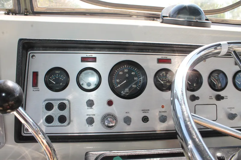 Slide: The Image of Instrument panel of a 1987 Chris-Craft 427 Catalina boat with gauges and controls. - 23