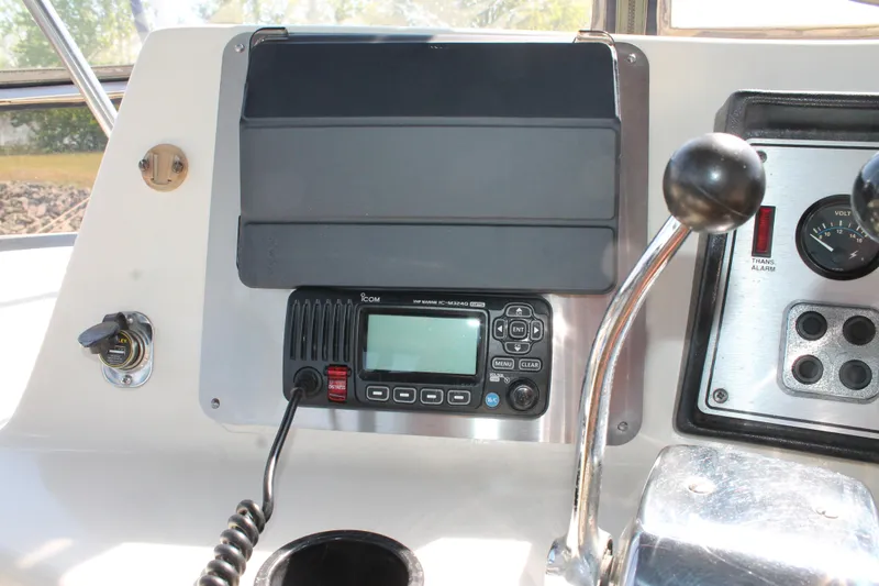 Slide: The Image of Control panel of 1987 Chris-Craft 427 Catalina with radio and throttle lever. - 25