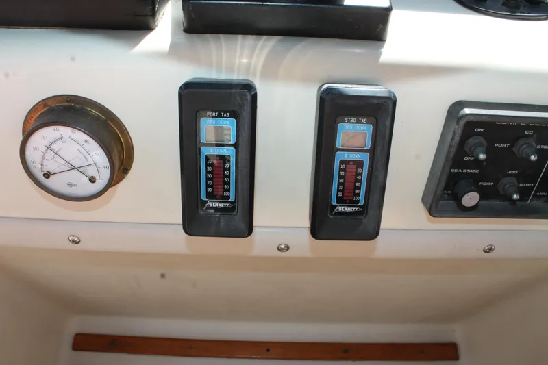 Slide: The Image of Control panel of a 1987 Chris-Craft 427 Catalina boat with gauges and switches. - 26