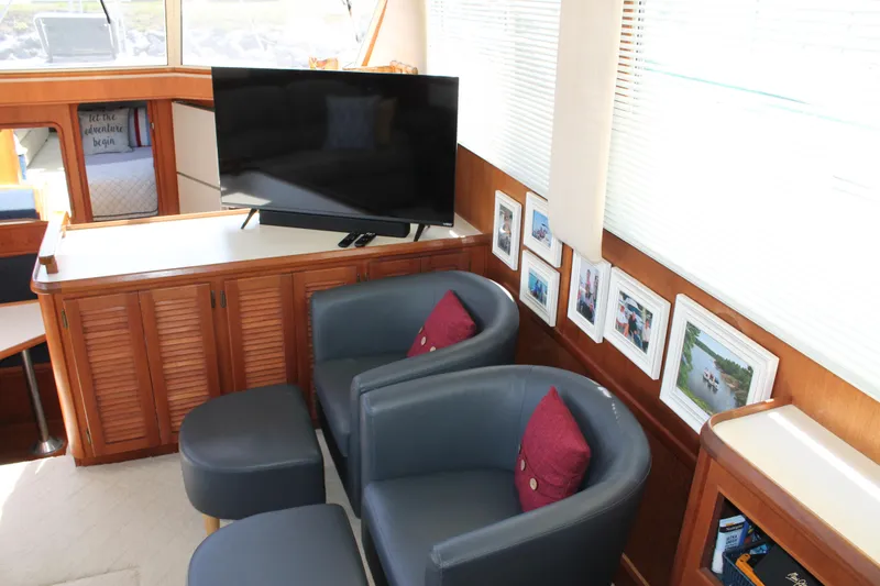 Slide: The Image of Interior of 1987 Chris-Craft 427 Catalina with TV, chairs, and framed photos. - 28