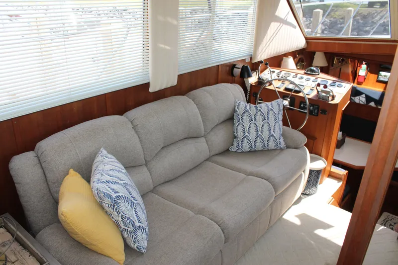 Slide: The Image of Interior of 1987 Chris-Craft 427 Catalina with plush sofa and nautical-themed decor. - 29