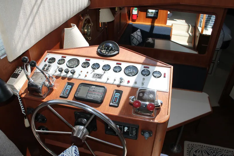 Slide: The Image of 1987 Chris-Craft 427 Catalina helm with classic wooden dashboard and navigational instruments. - 31