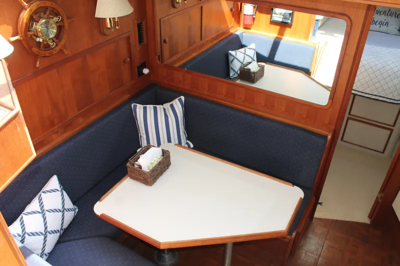Slide: The Image of 1987 Chris-Craft 427 Catalina interior with cozy dining area and nautical decor. - 32