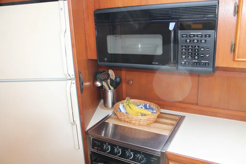 Slide: The Image of 1987 Chris-Craft 427 Catalina kitchen with microwave, stove, and fruit basket. - 34