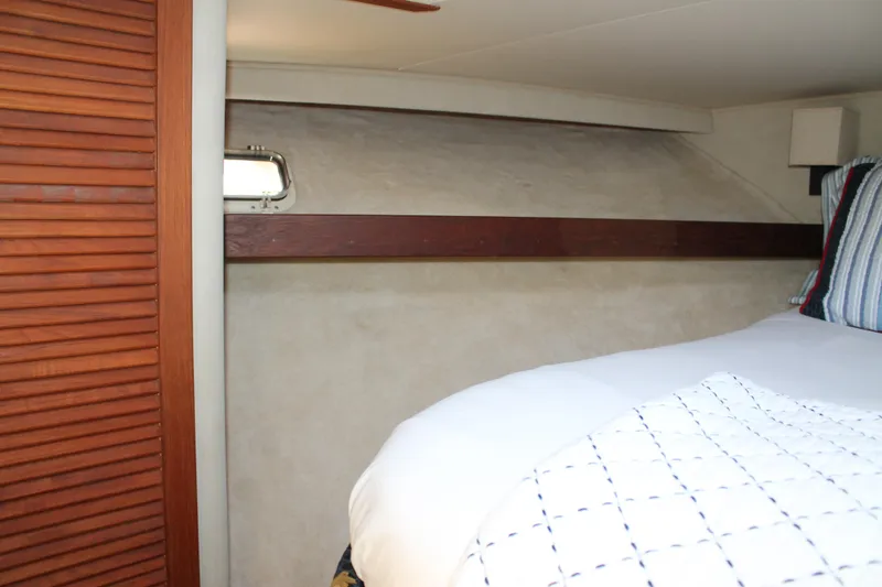 Slide: The Image of Cozy cabin interior of 1987 Chris-Craft 427 Catalina with wooden accents and bedding. - 36
