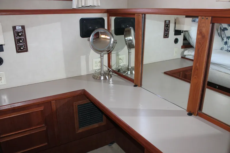 Slide: The Image of Interior of 1987 Chris-Craft 427 Catalina with vanity mirror and wooden cabinetry. - 44