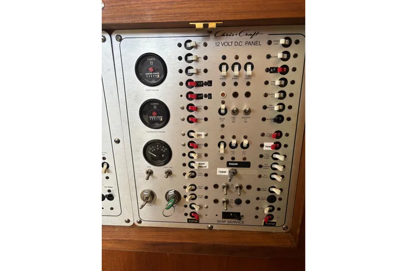 Slide: The Image of 1987 Chris-Craft 426 Catalina control panel with gauges and switches for ship service. - 47