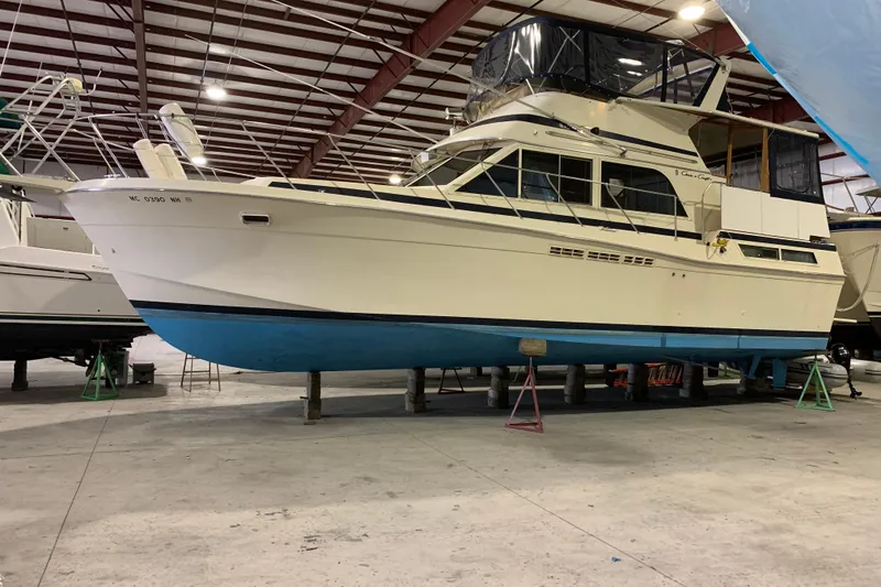 Slide: The Image of 1987 Chris-Craft 427 Catalina yacht in storage, showcasing classic design and blue hull. - 6