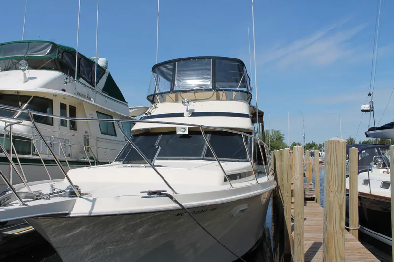 Slide: The Image of 1987 Chris-Craft 427 Catalina yacht docked at marina under clear blue sky. - 8