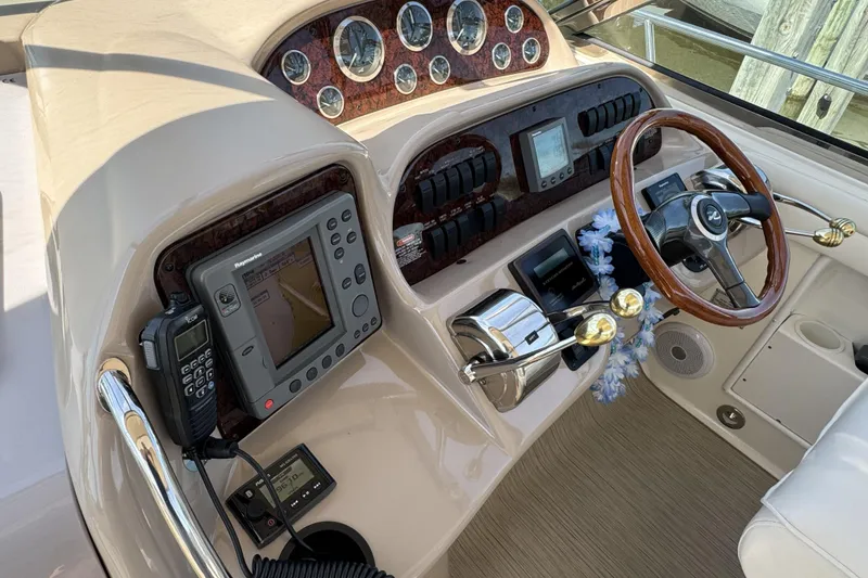 Slide: The Image of Helm of 2002 Sea Ray 360 Sundancer with navigation equipment and wooden steering wheel. - 15