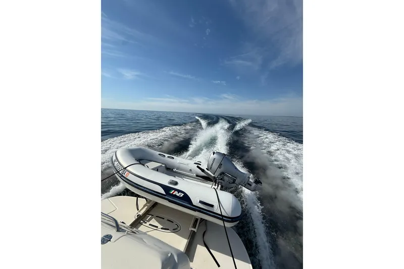 Slide: The Image of Sea Ray 360 Sundancer 2002 cruising with inflatable boat on calm ocean waters. - 2
