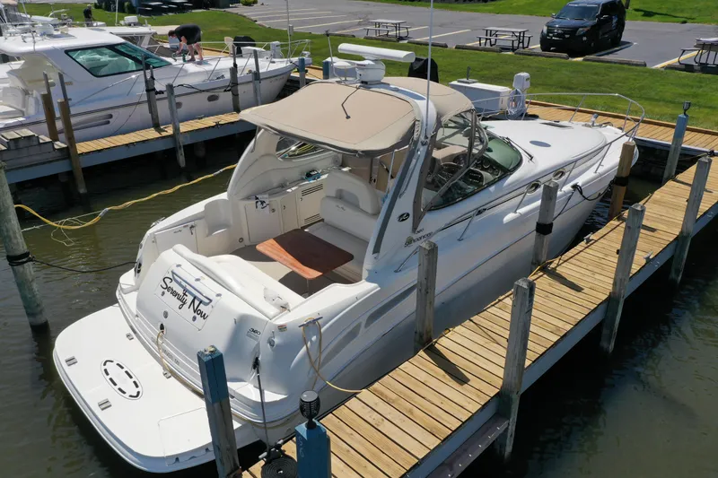 Slide: The Image of 2002 Sea Ray 360 Sundancer docked at marina, featuring spacious deck and elegant design. - 3